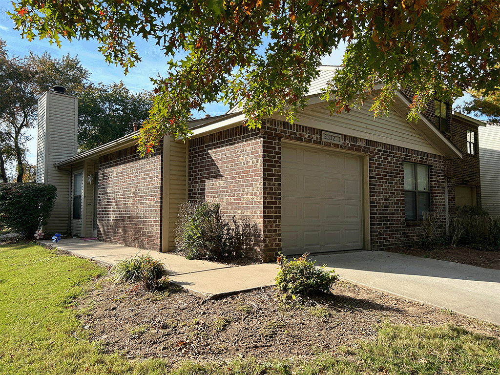 a brick house with a white garage door