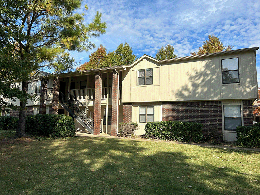 our apartments have a spacious yard with green grass and trees