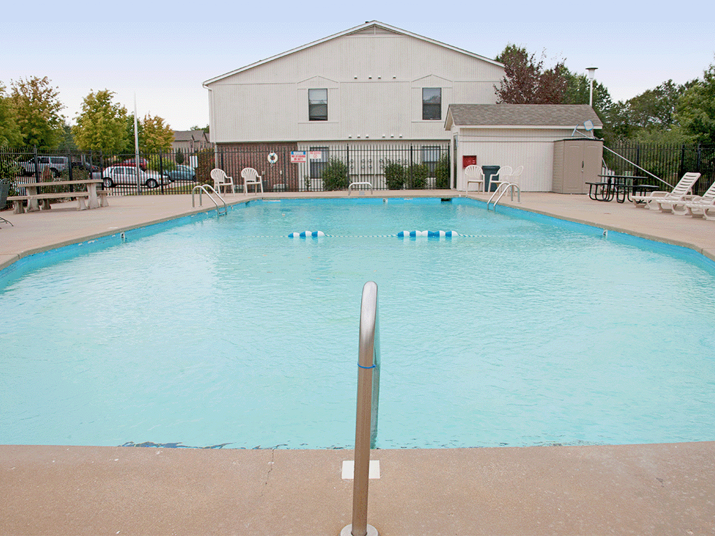 a swimming pool with a building in the background
