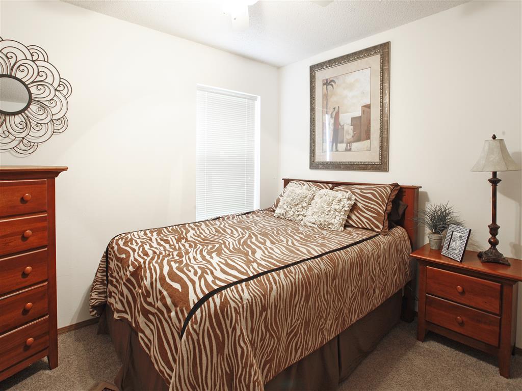 a bedroom with a bed and a dresser and a window