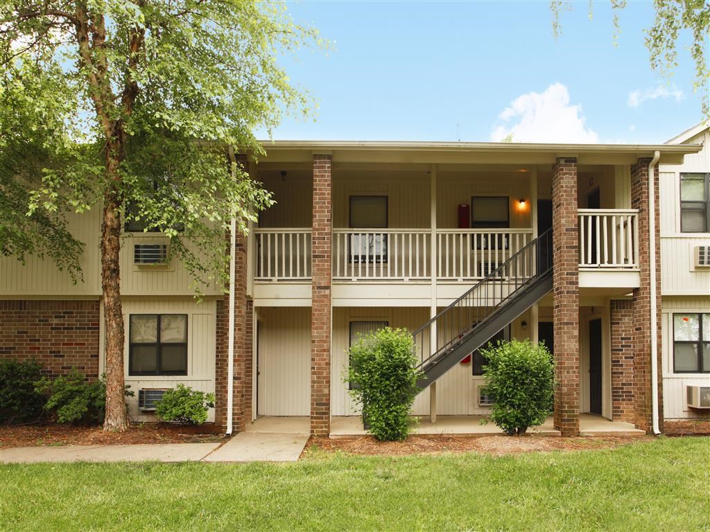 an apartment building with a balcony and a staircase