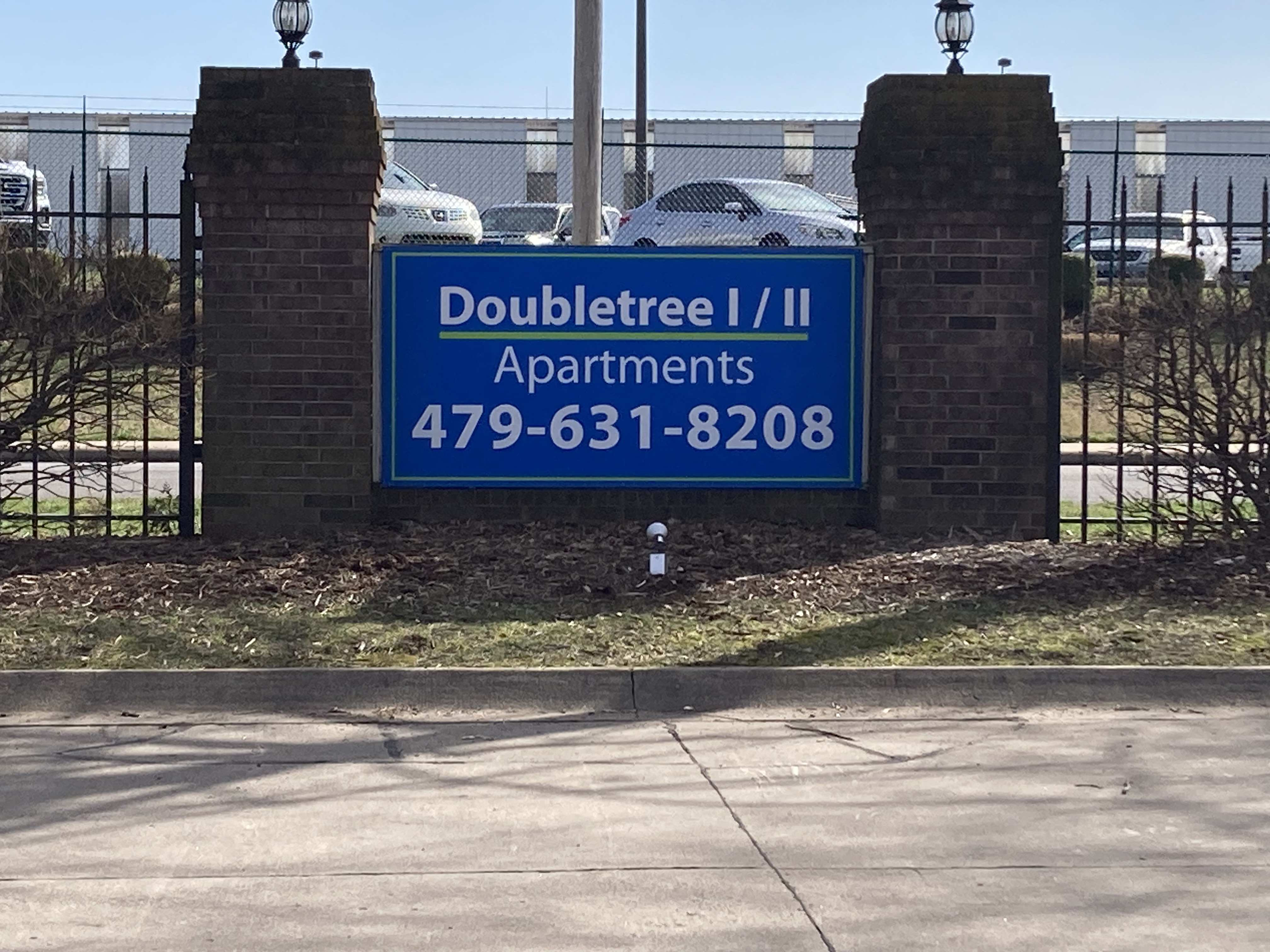 a sign in front of a parking lot