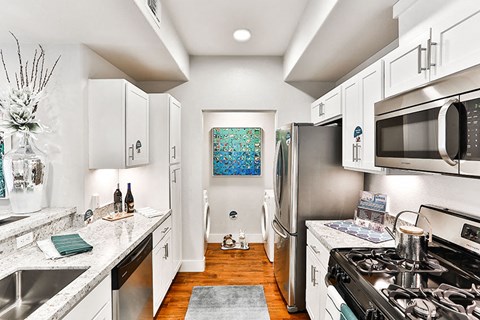 a kitchen with stainless steel appliances and white cabinets
