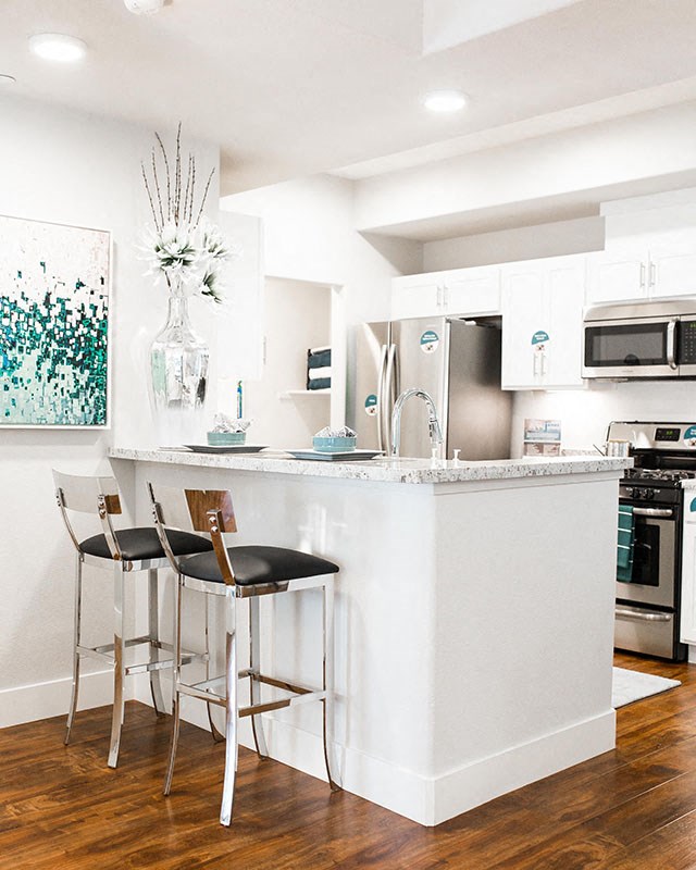 Rocklin Apartments for Rent - The James - Kitchen with Custom Shaker Style Cabinets, Stainless Steel Kitchen Appliances, and High-Grade Granite Counter Tops