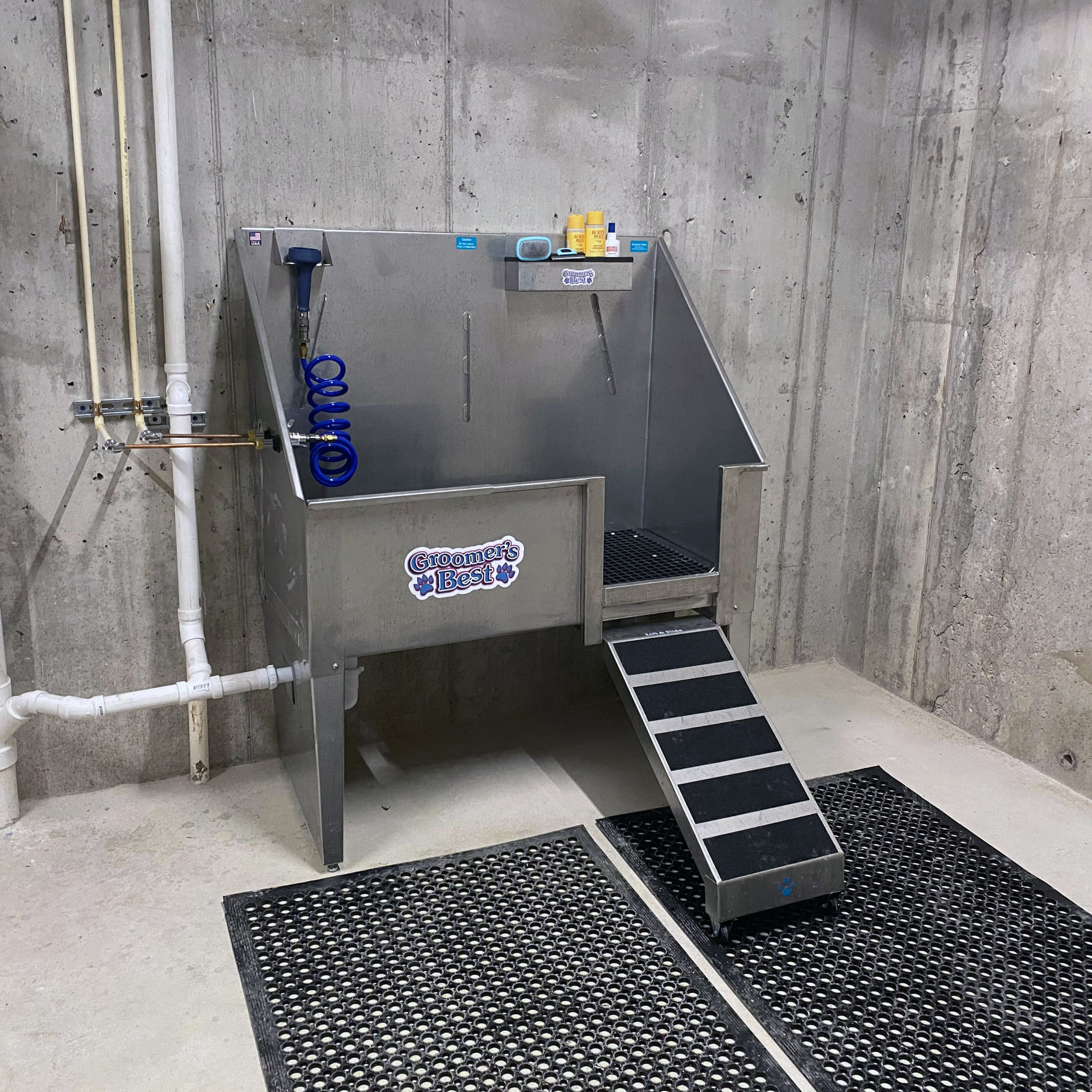 a large stainless steel grill in a room with a staircase