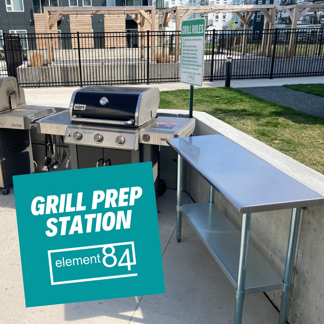 a grill prep station with a table and a bbq grill