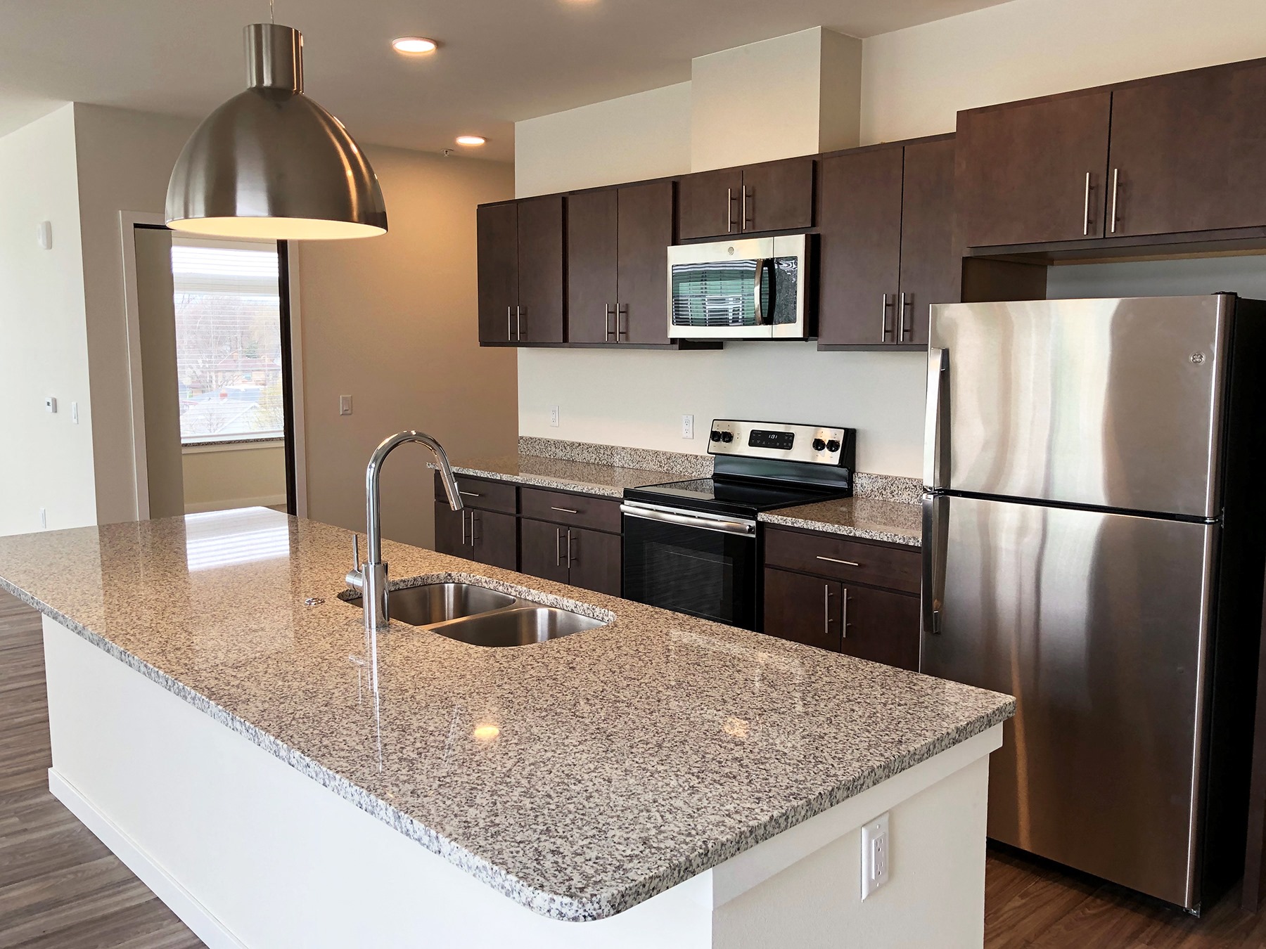a kitchen with stainless steel appliances and a granite counter top