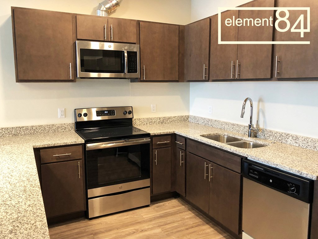 a kitchen with stainless steel appliances and granite counter tops
