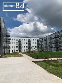 an image of an apartment building with a cloudy sky