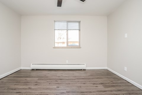 A room with a window and a bench.