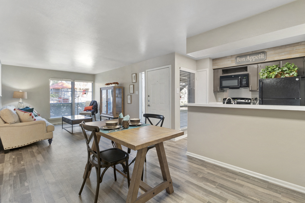 an open living room and kitchen with a table and chairs