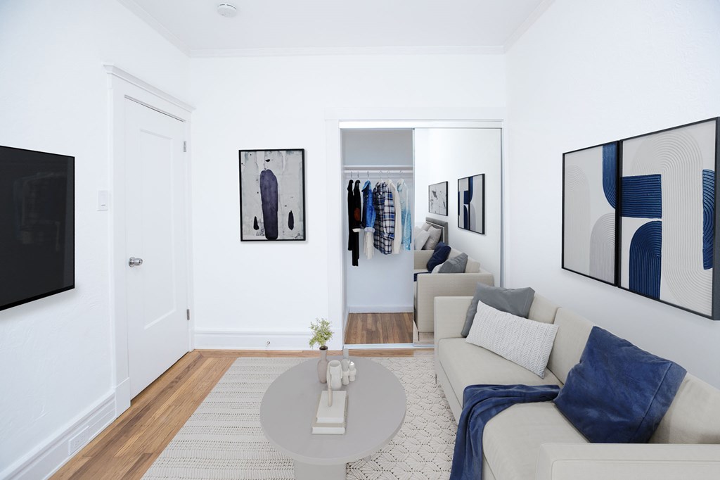 A living room with a white couch and a coffee table.