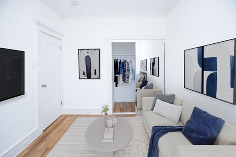 A living room with a white couch and a coffee table.