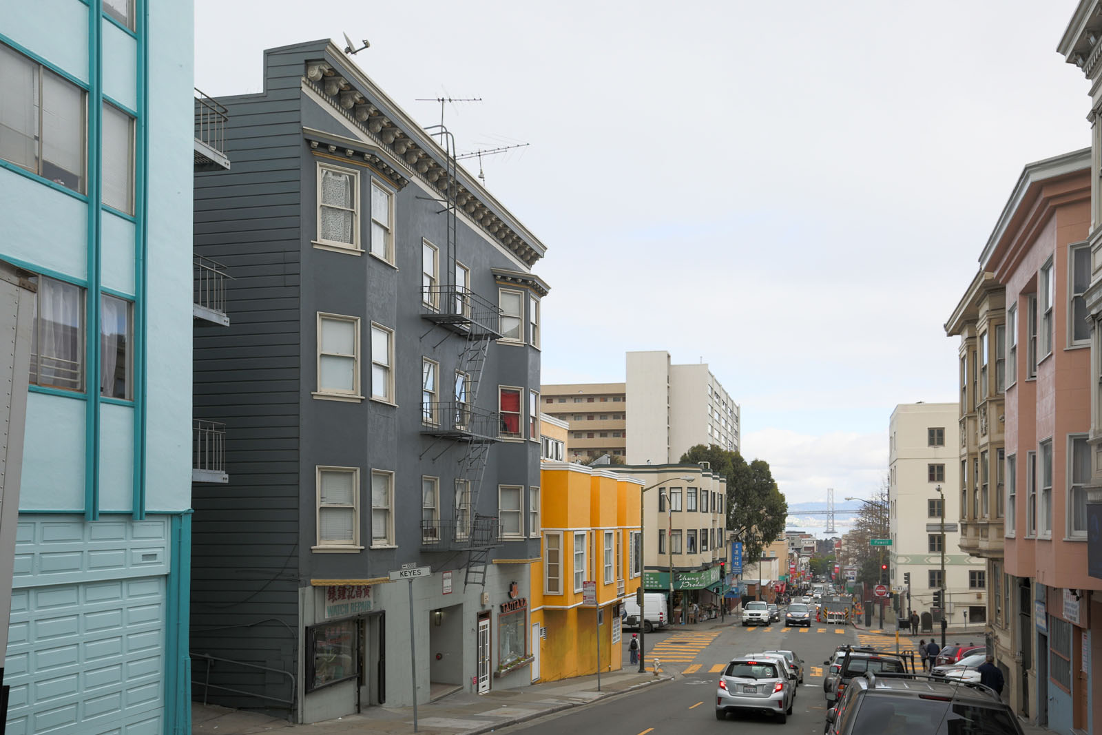 A street view of a city with cars and buildings.