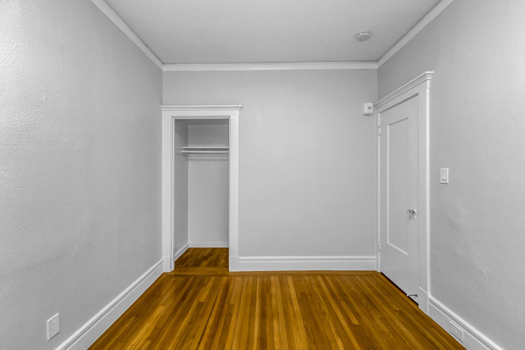A room with white walls and wooden flooring.