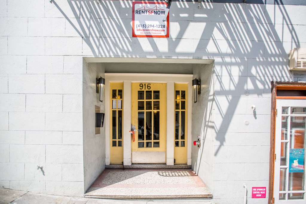 The front door of a building with a sign that says "Rent Spot".