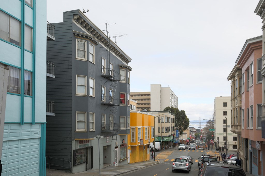 A street view of a city with cars and buildings.