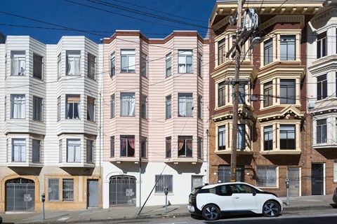 a car parked in front of a building on a city street