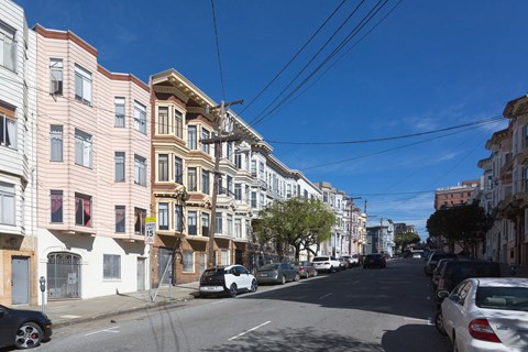 a city street with cars parked on the side of a