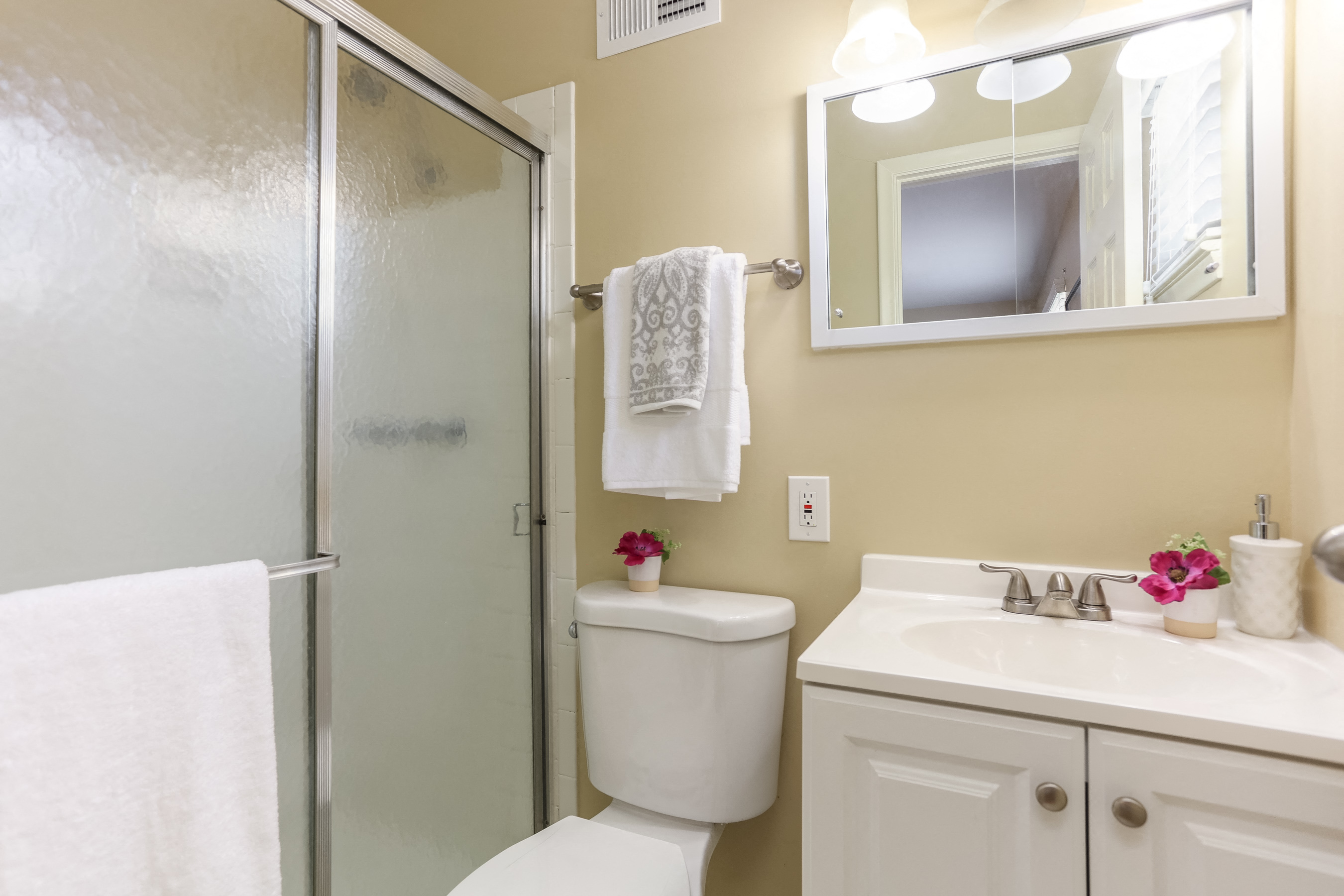 a bathroom with a shower and a sink and a toilet