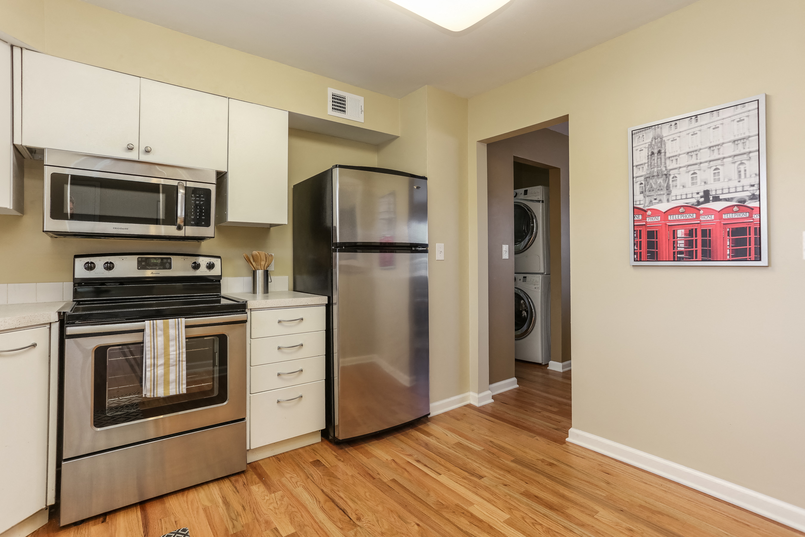 a kitchen with stainless steel appliances and a refrigerator