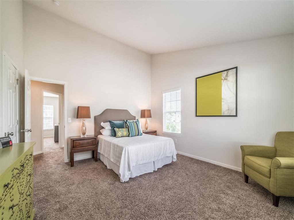 a bedroom with a bed and a chair