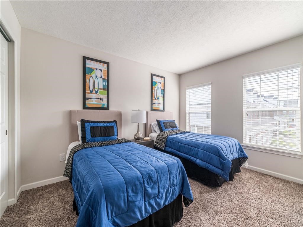 a bedroom with two beds and a window