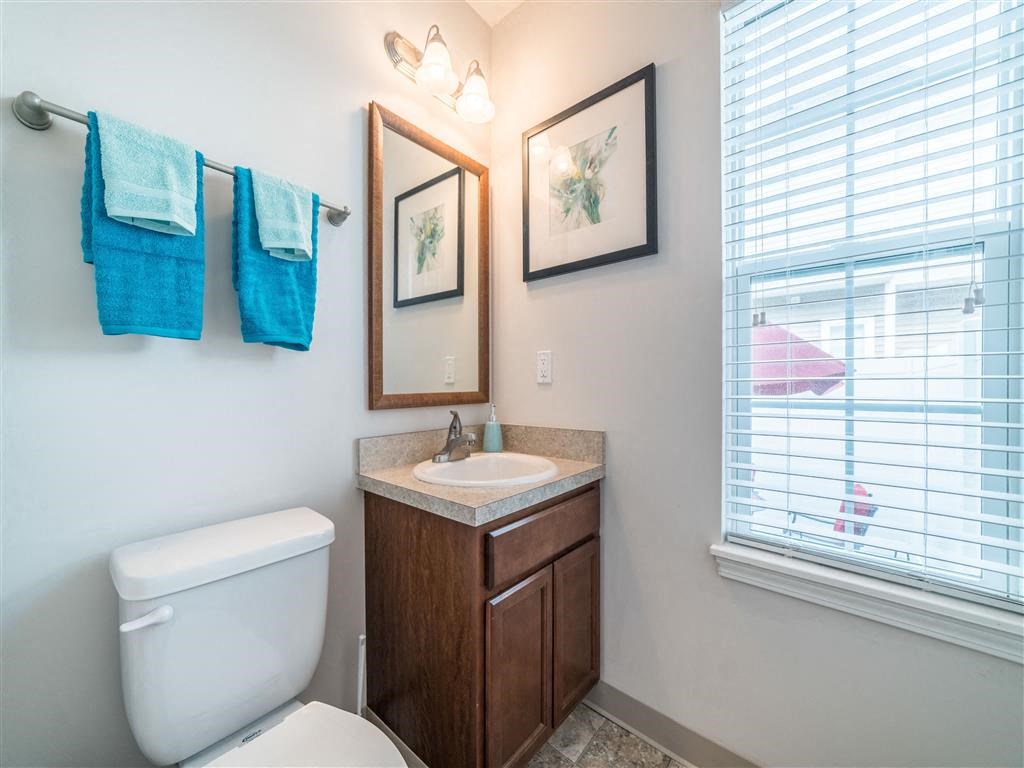 a bathroom with a toilet sink and a window