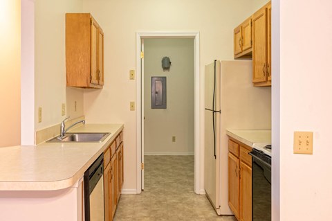 Kitchen With Attached Laundry Room At Blueberry Hill Apartments, Rochester, NY