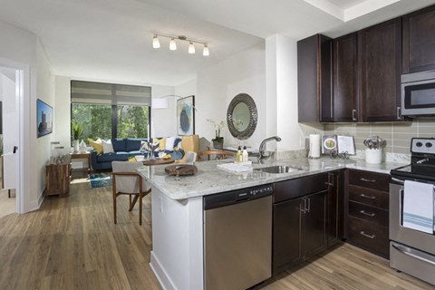 A modern kitchen with dark wood cabinets and a white island.
