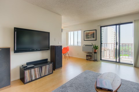 a living room with a tv and a sliding glass door