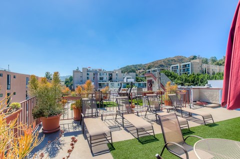 Rooftop deck with lounge chairs and hillside views at Joro Properties Apartments, Hollywood, CA 90046