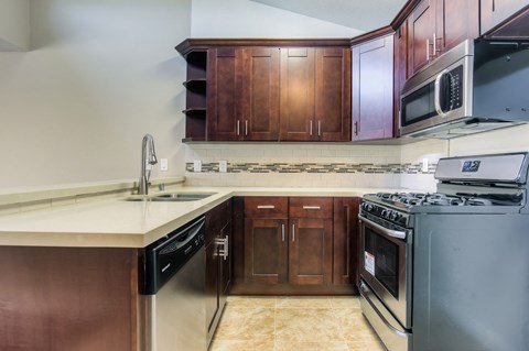 a kitchen with stainless steel appliances and wooden cabinets