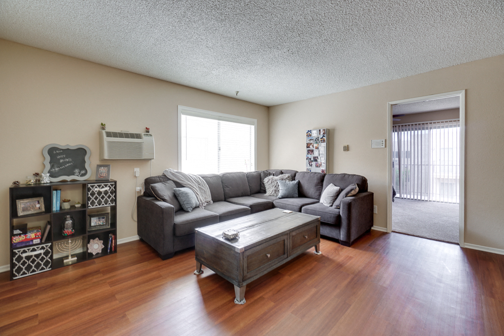 the living room of an apartment with a couch and a coffee table