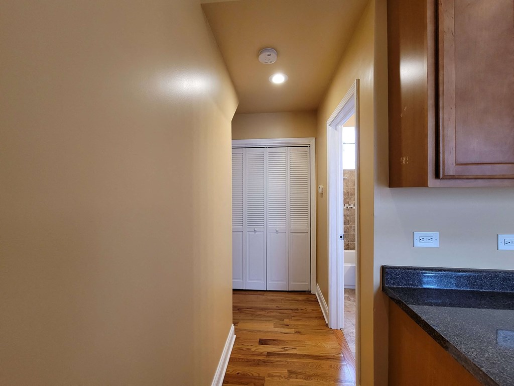 a hallway with a door to a closet in a house