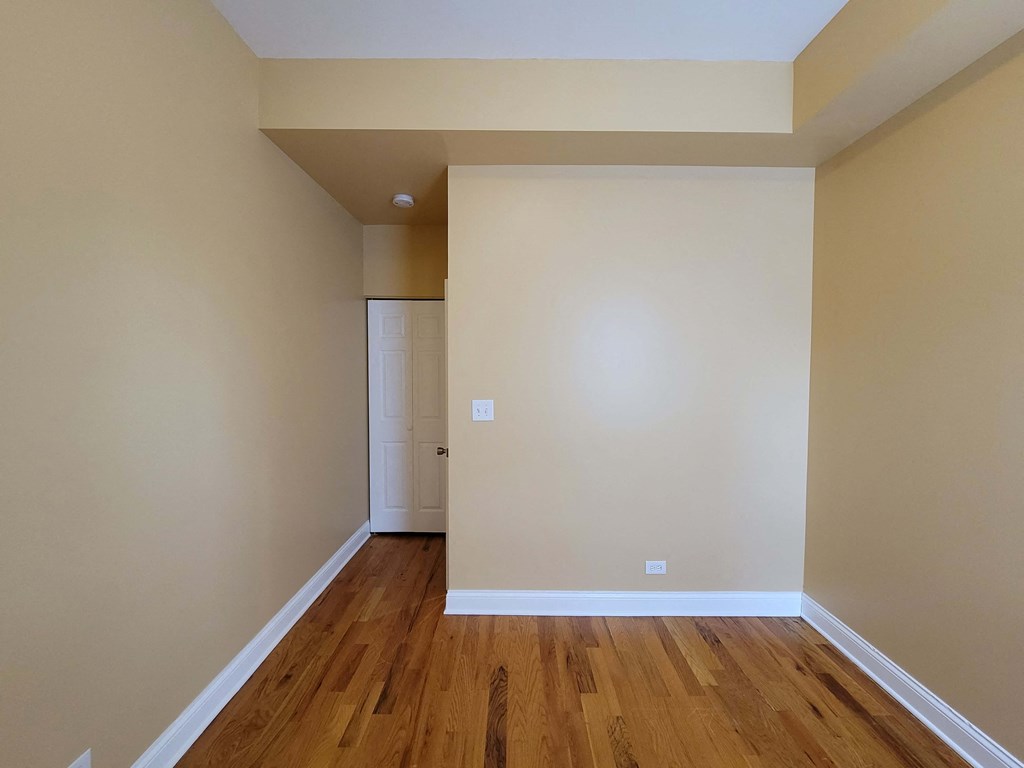 a empty room with wood floors and a door