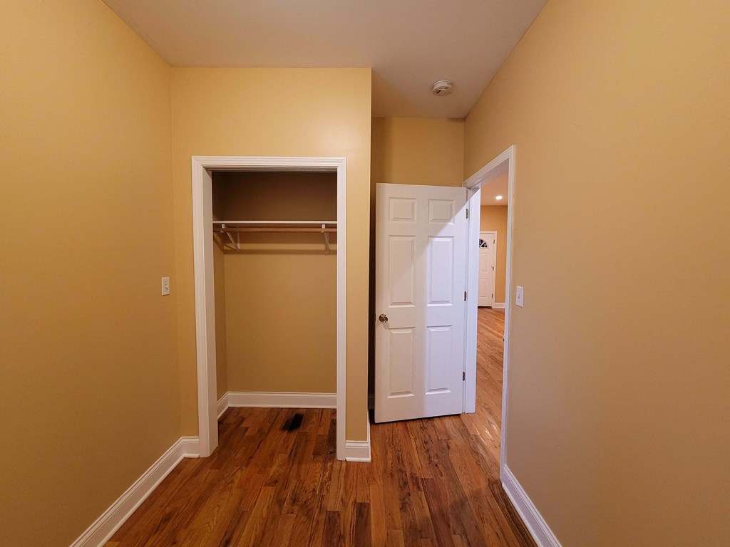 a bedroom with a closet and an open door