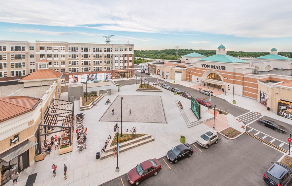 an aerial view of a shopping center with cars and buildings