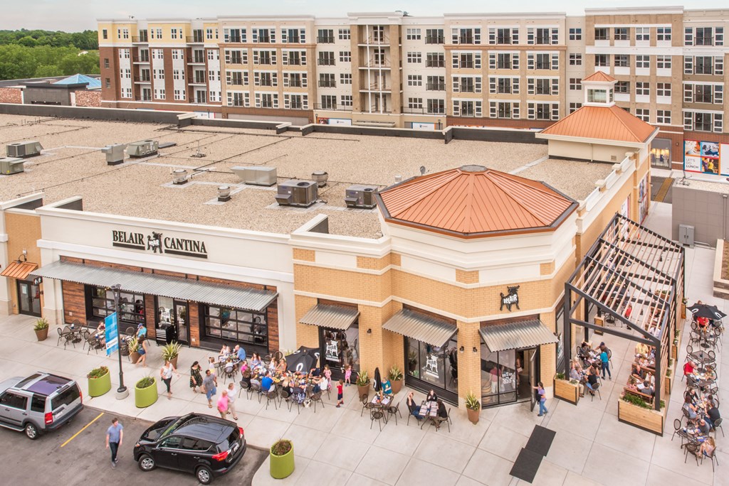 an aerial view of a shopping center with a large building and a crowd of people