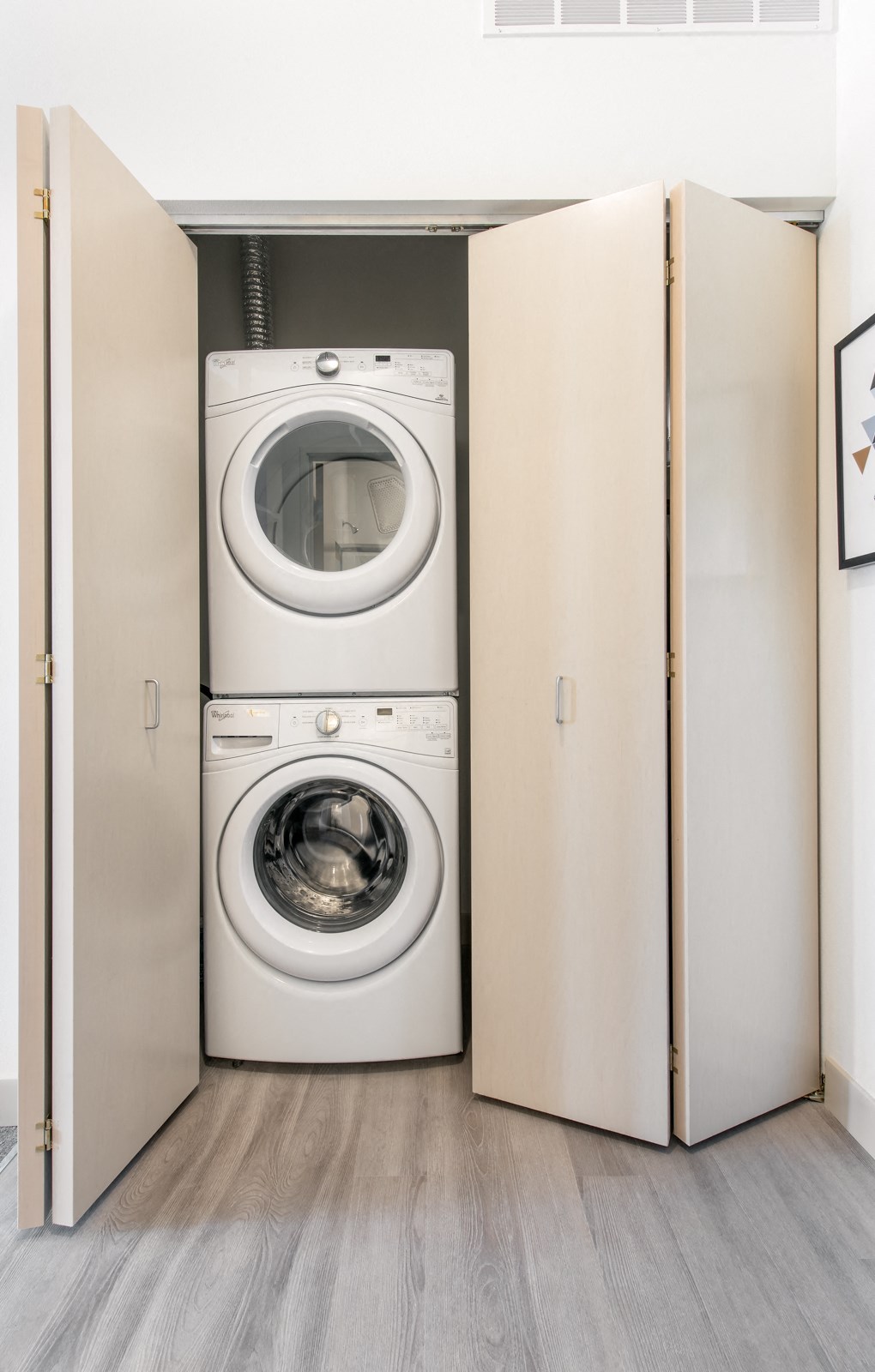 a white washer and dryer in a closet