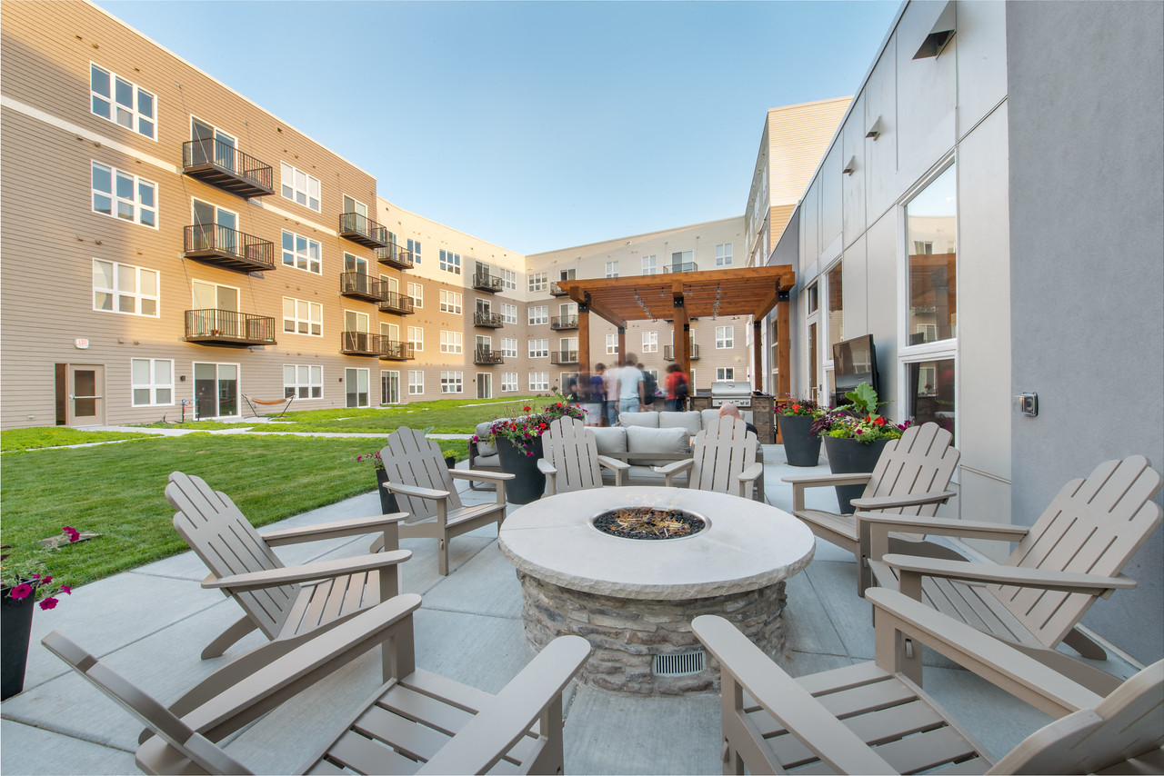 an outdoor patio with chairs and a fire pit