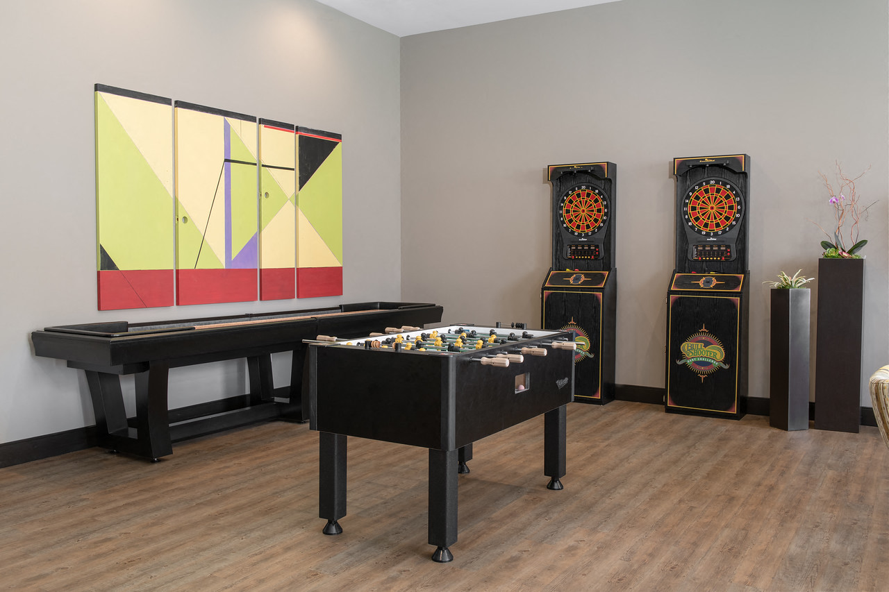 a game room with a foosball table and other gaming equipment