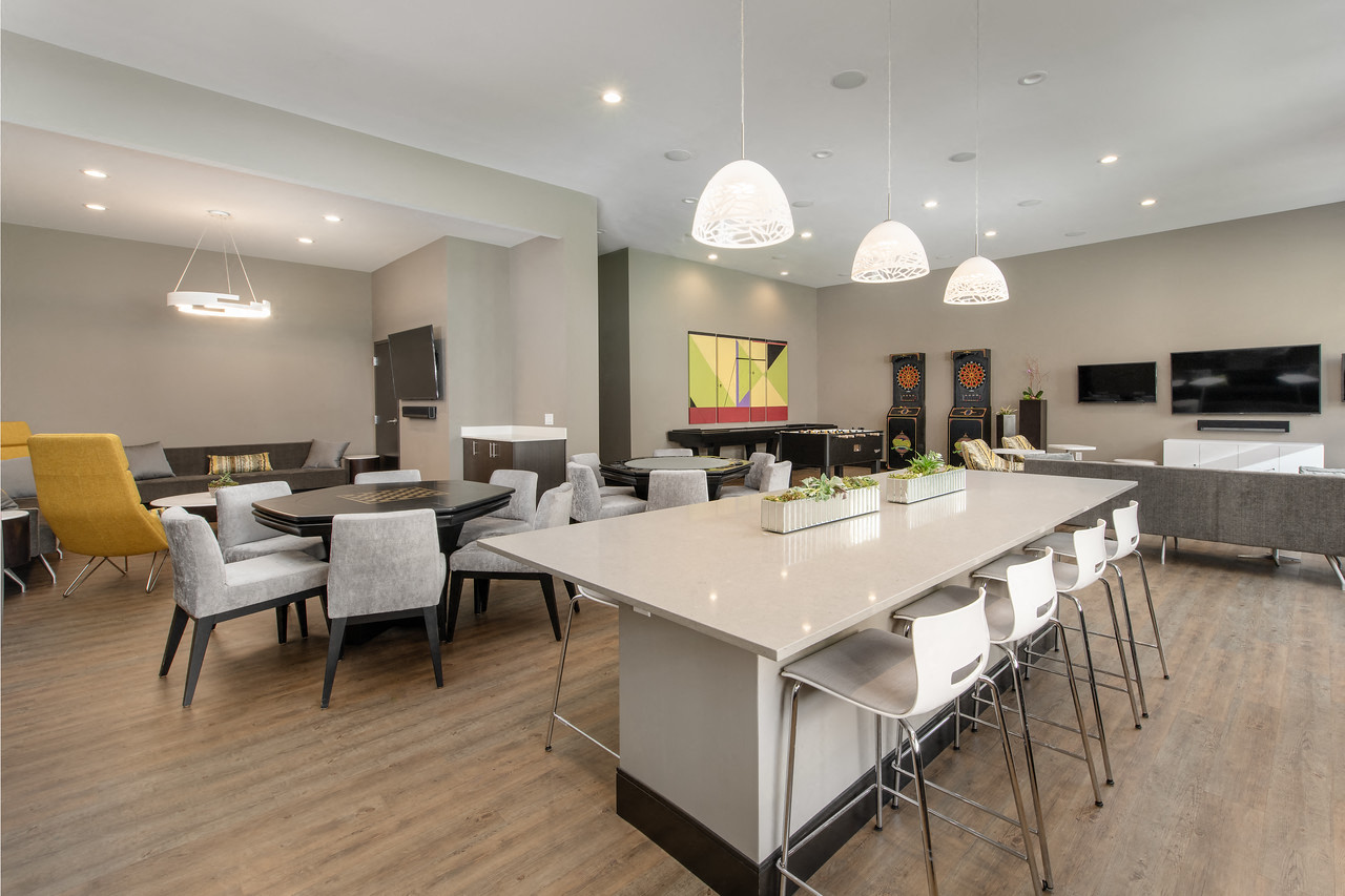 a communal table and chairs in a room with tables and chairs