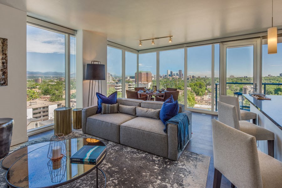 a living room with a couch and a view of the city
