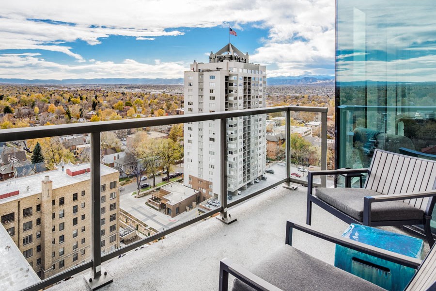 a balcony with a view of a city and a skyscraper