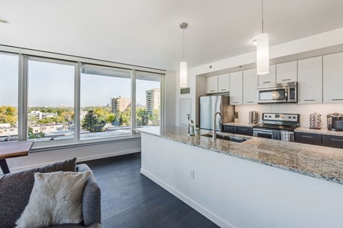 a kitchen with a counter top and a large window