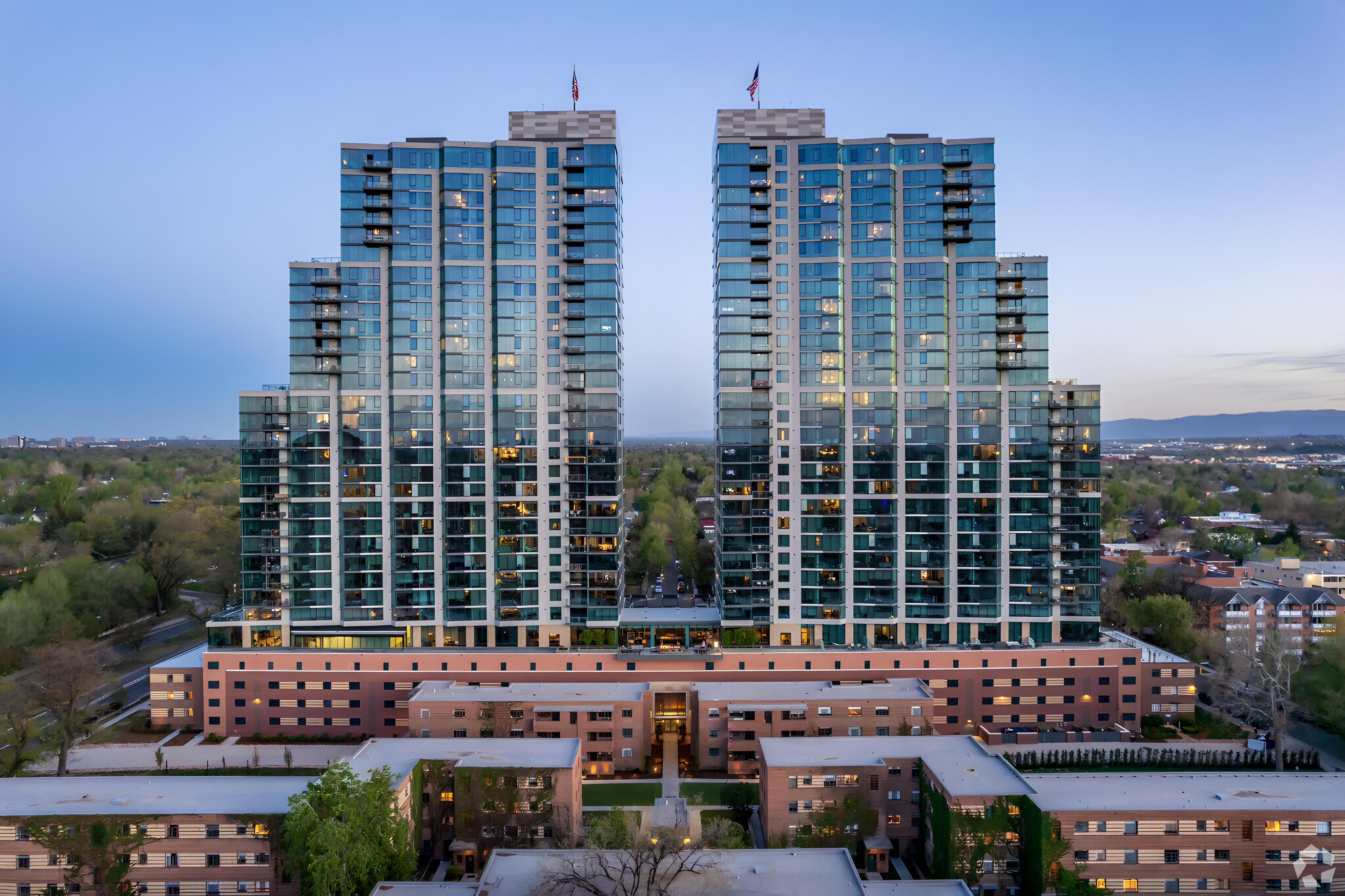 two tall skyscrapers with a city in the foreground