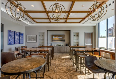 a dining room with tables and chairs and a bar