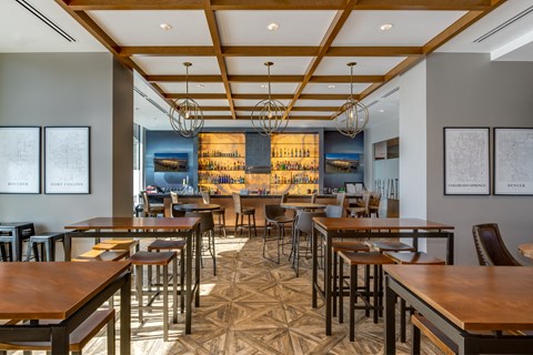 a dining room with tables and chairs and a bar