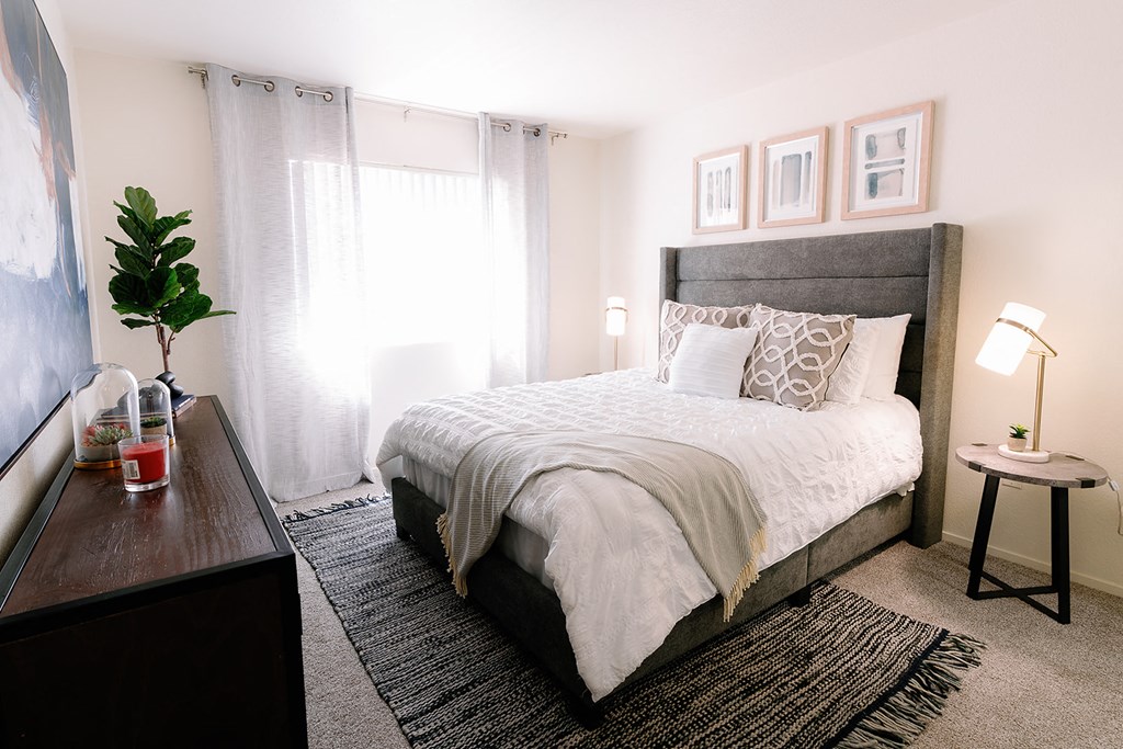 a bedroom with a bed and a dresser